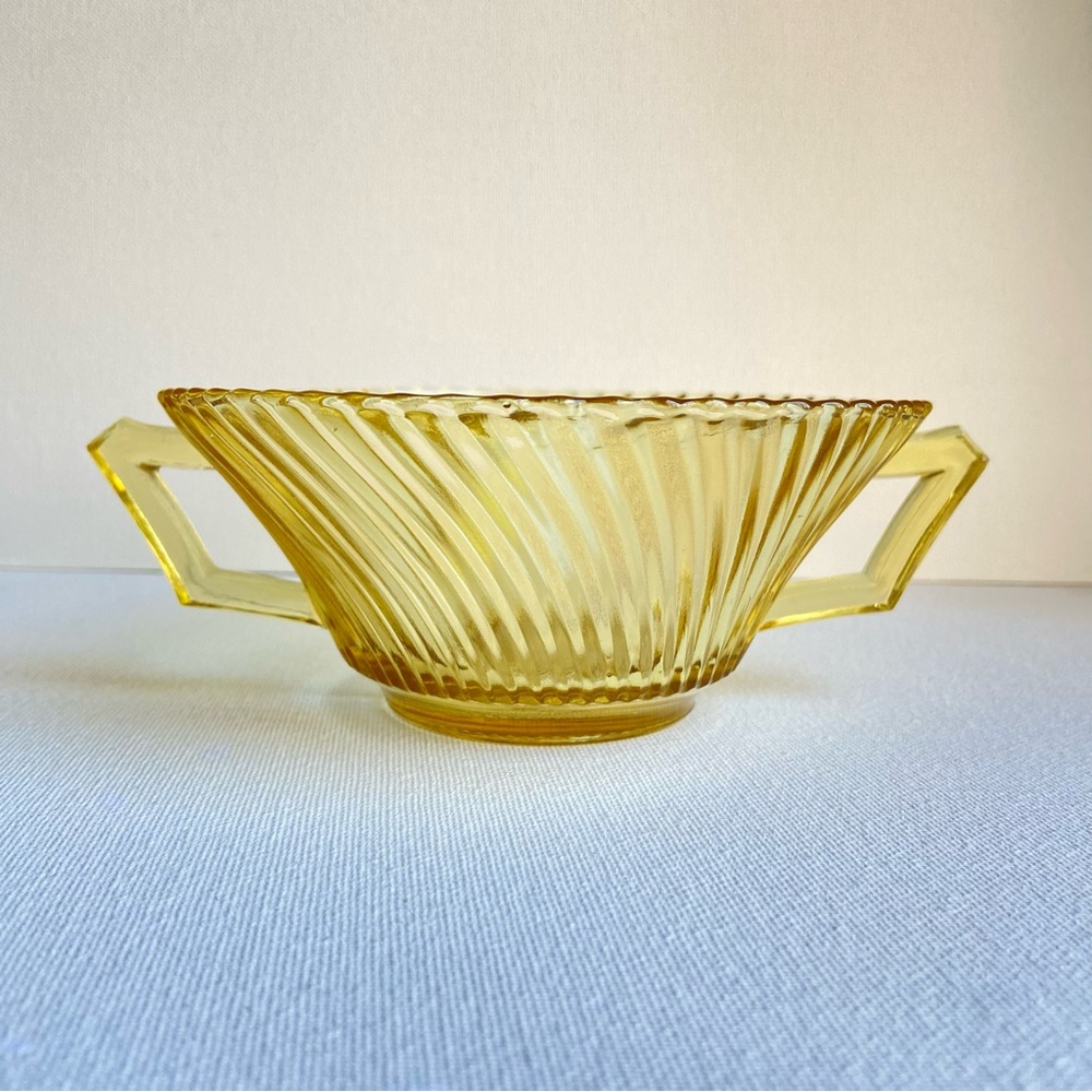 Vintage yellow pressed depression glass bowl with handles and ribbed swirls